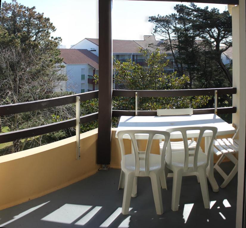 a white table and chairs on a balcony at Anglet plage T2 vue parc Atlantide in Anglet