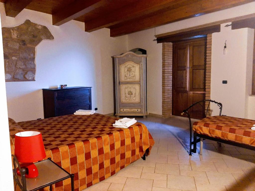 a hotel room with two beds and a door at Il Borgo & il Feudo in Badolato