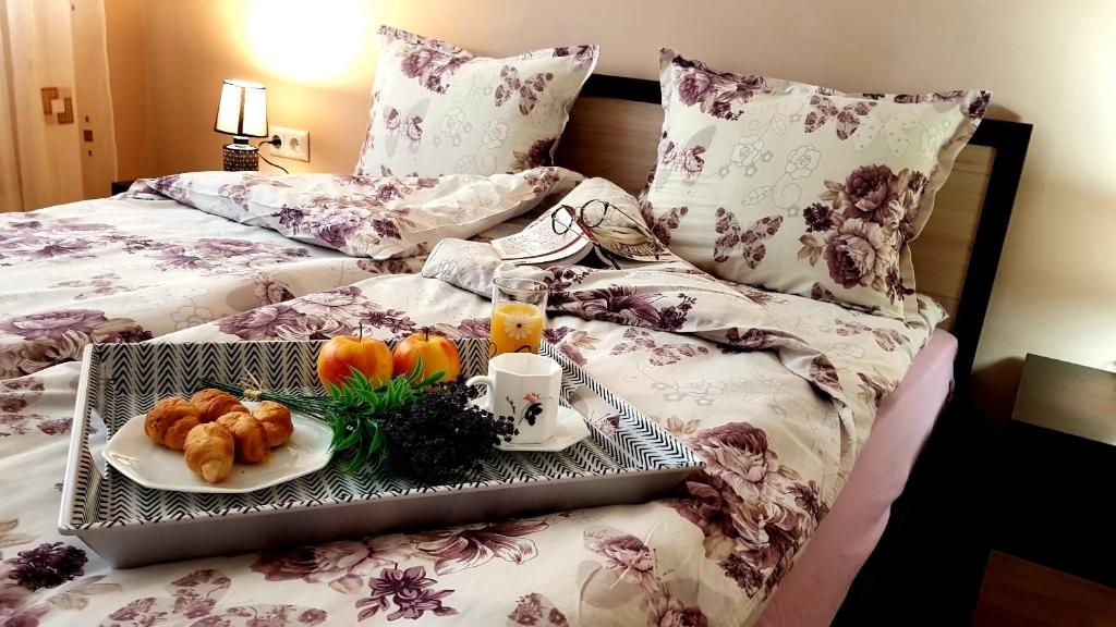 a tray with breakfast foods on a bed at Studio Kamelia in Kazanlŭk