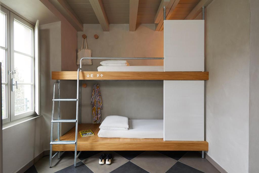 a room with a bunk bed with a ladder at Combo Milano in Milan