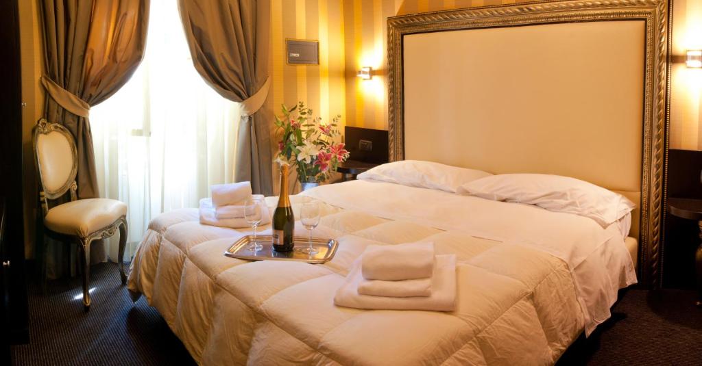 a hotel room with a bed with towels on it at Domus RomAntica in Rome