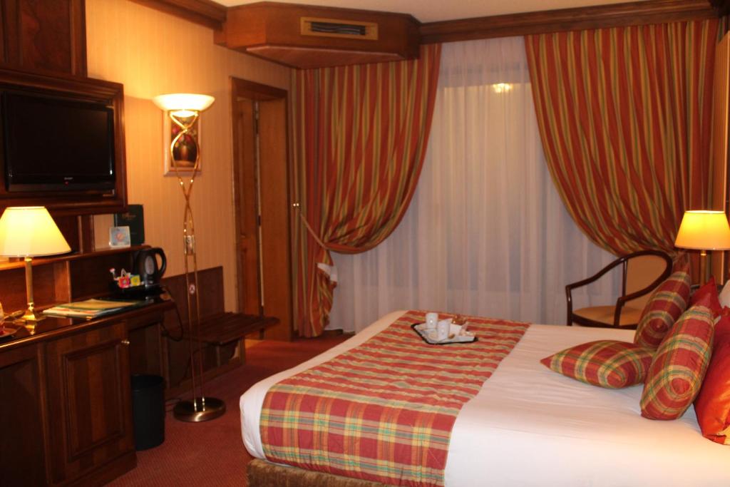 Postel nebo postele na pokoji v ubytování Hotel Le Mandelberg