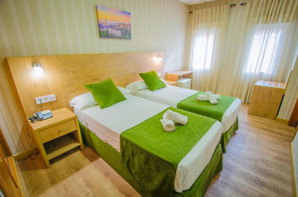 Säng eller sängar i ett rum på Hotel Solymar