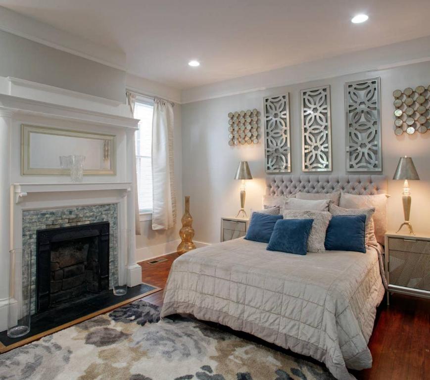 a bedroom with a bed and a fireplace at Huge 5 bed, 5 bath in Historic Downtown Savannah in Savannah