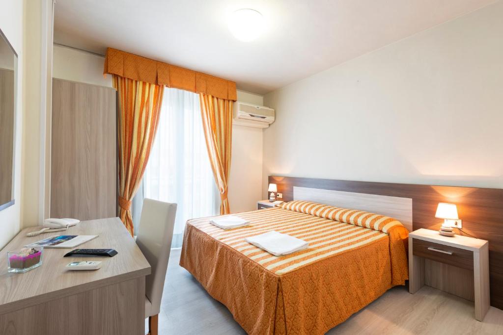 Postel nebo postele na pokoji v ubytování Hotel Columbus