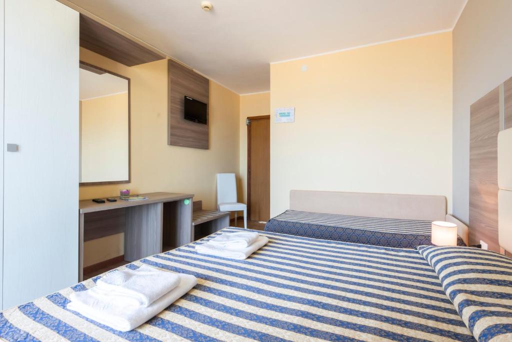 Postel nebo postele na pokoji v ubytování Hotel Columbus