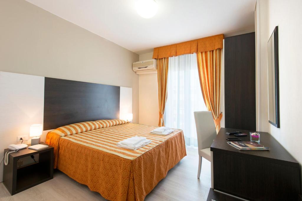 Postel nebo postele na pokoji v ubytování Hotel Columbus