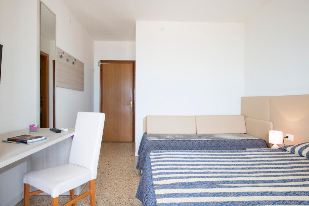 Postel nebo postele na pokoji v ubytování Hotel Columbus