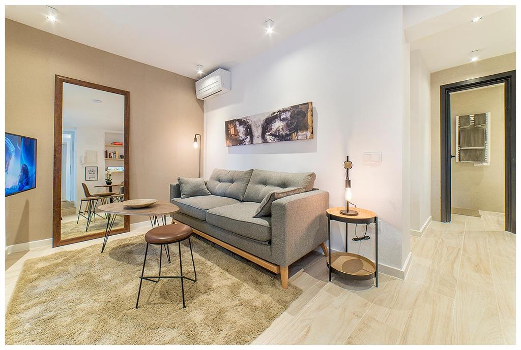 a living room with a couch and a table at Apartamentos Madrid Rio in Madrid
