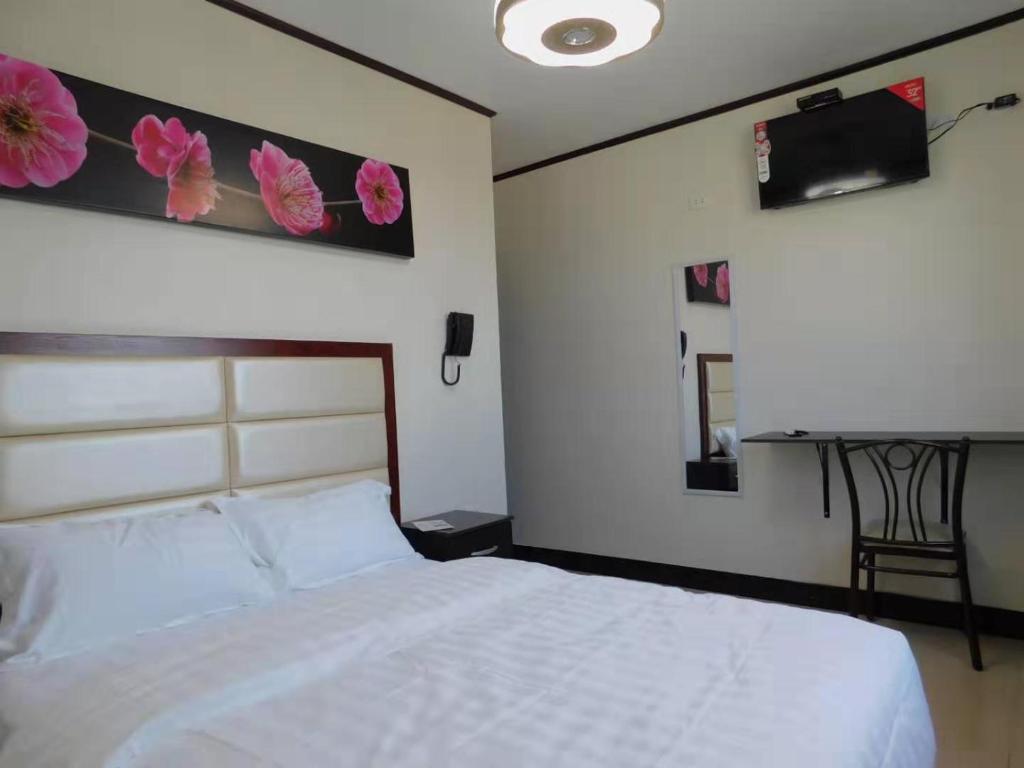Voodi või voodid majutusasutuse Sunshine Hotel toas