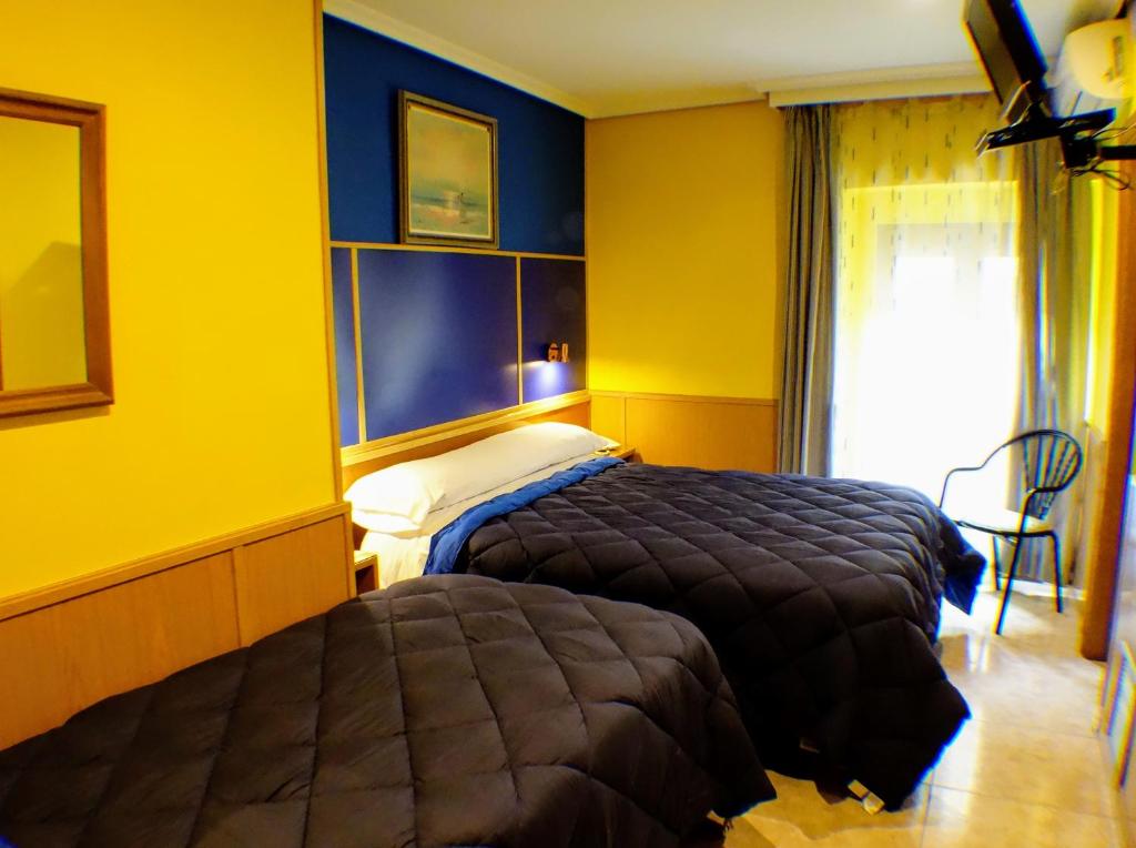 Postel nebo postele na pokoji v ubytování Trípolis Toledo