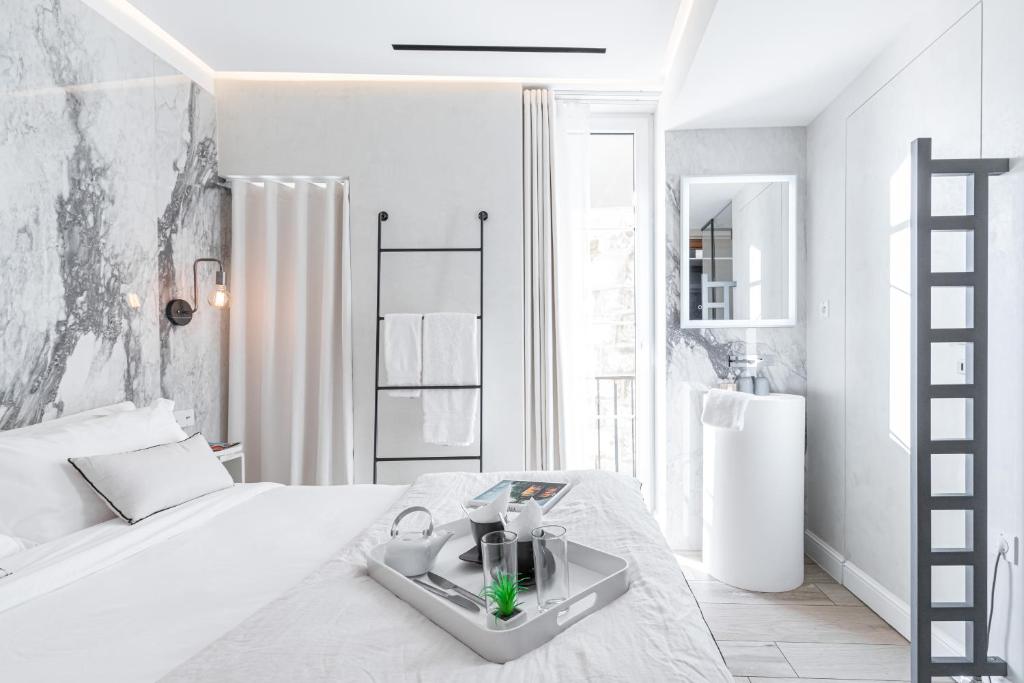 Postel nebo postele na pokoji v ubytování Le Dortoir Boutique Suites