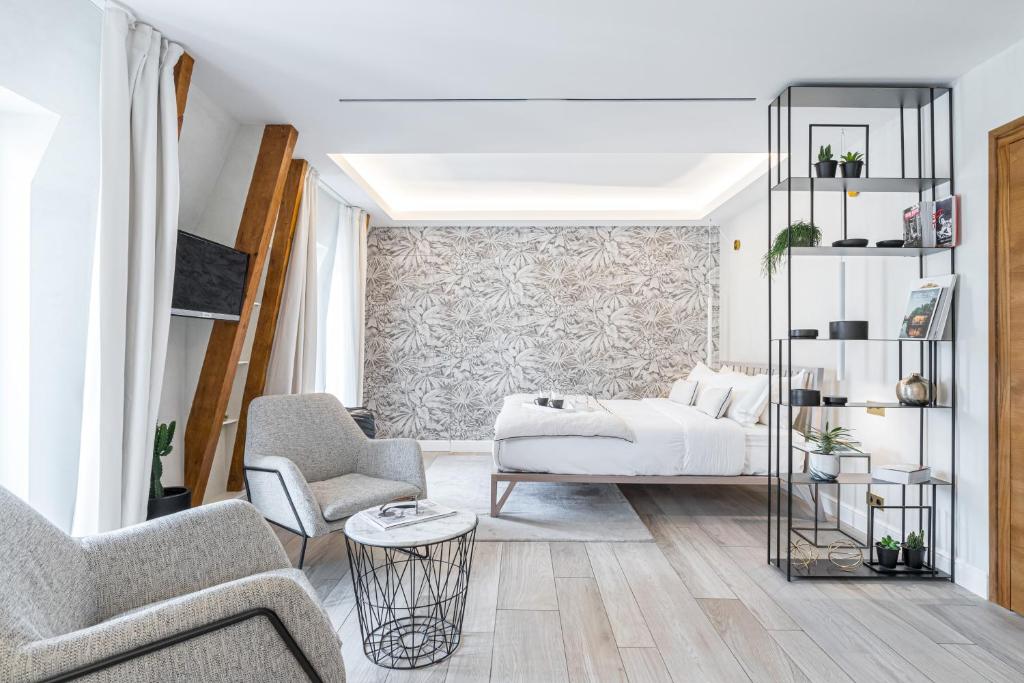 Postel nebo postele na pokoji v ubytování Le Dortoir Boutique Suites