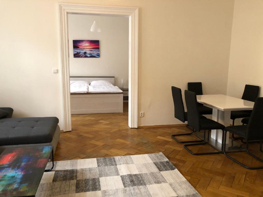 a living room with a couch and a table and a mirror at Welcome Hostel & Apartments Praguecentre in Prague