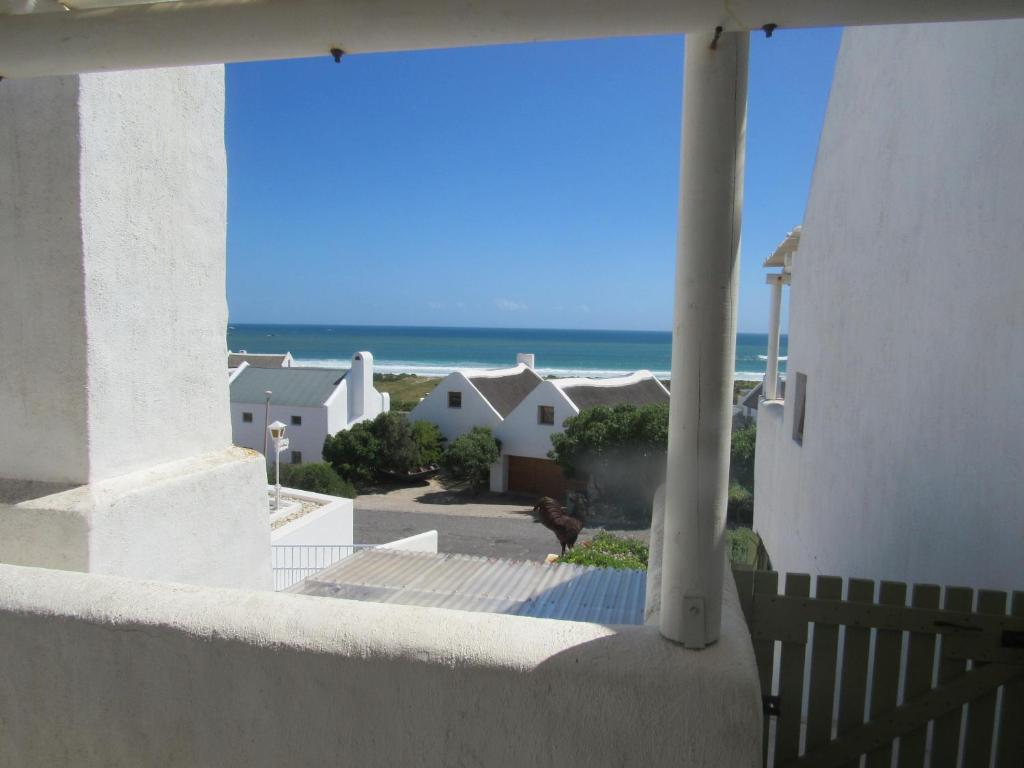 a view of the ocean from the balcony of a house at Marlyn and Dolfyn Self Catering in Paternoster