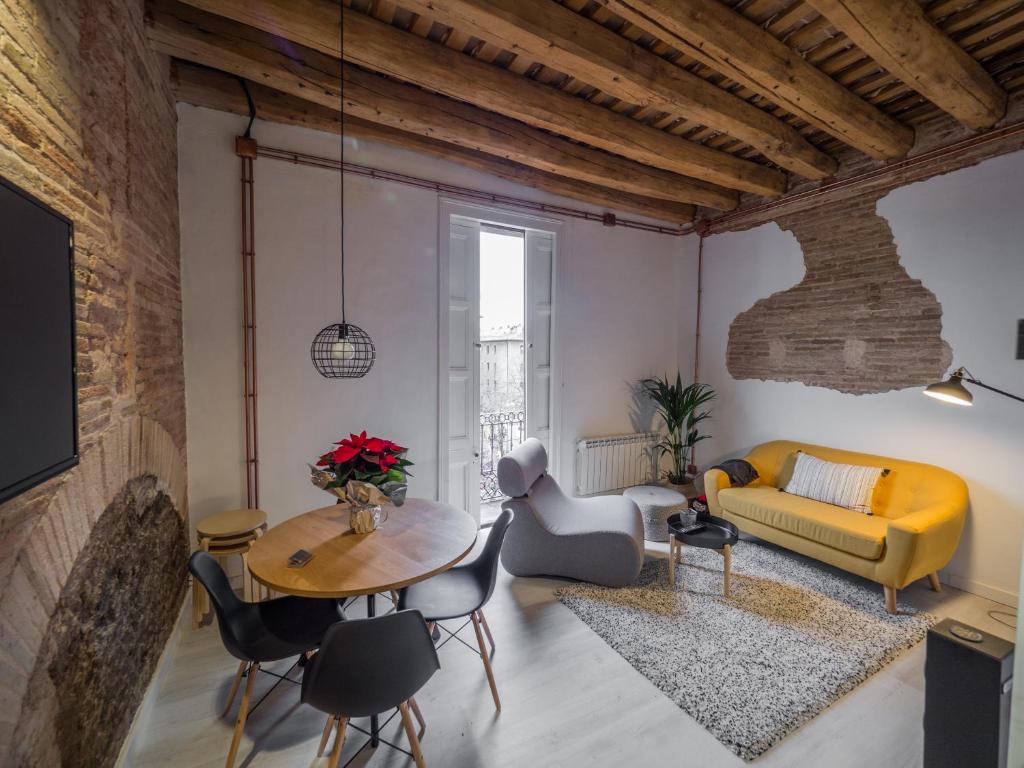 a living room with a table and a yellow couch at Luxury Apartment Stancesvic in Vic