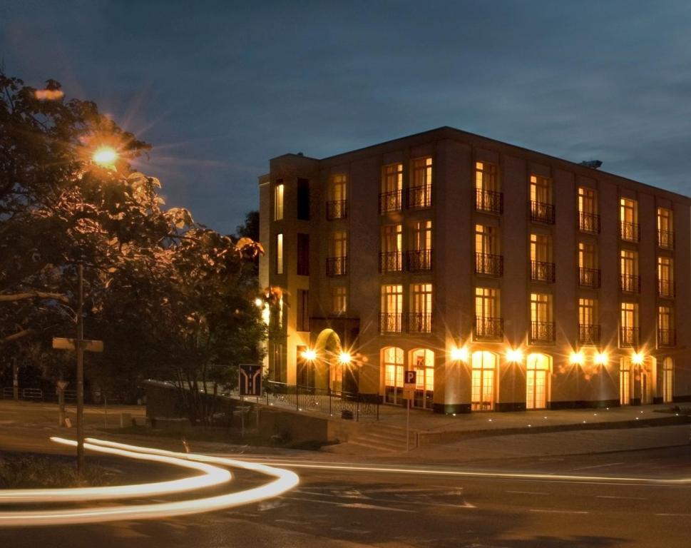 a building with lights in front of a street at Luxury Garni Hotel Brix in Bratislava