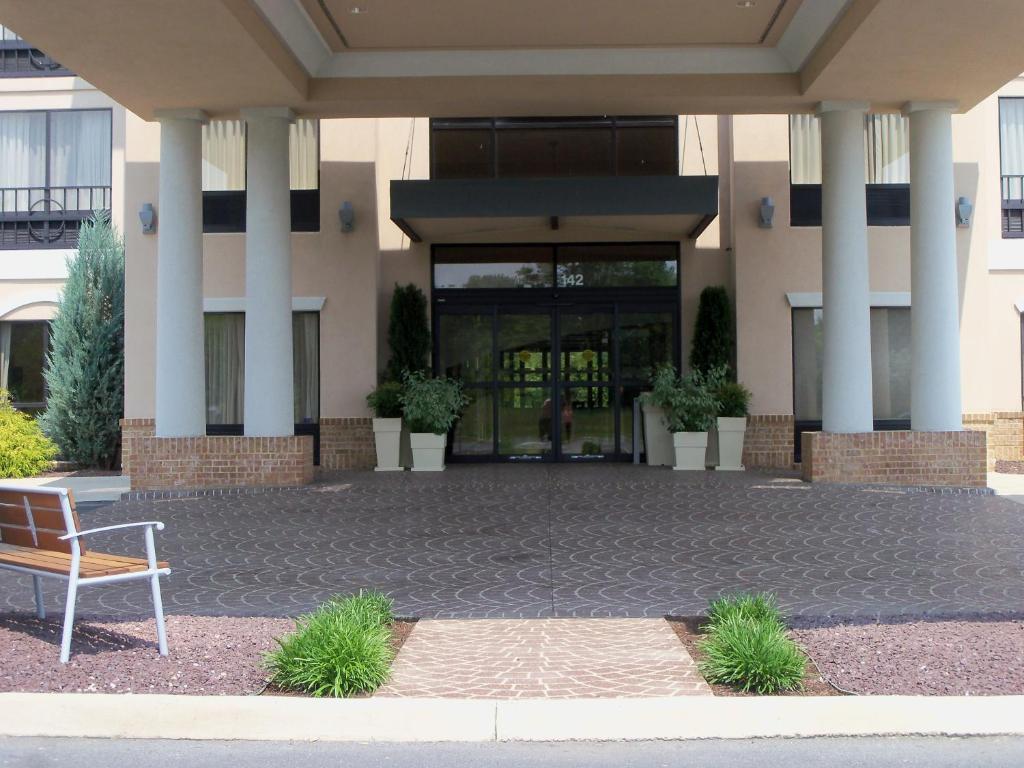 a bench sitting in front of a building at Holiday Inn Express and Suites Winchester by IHG in Winchester