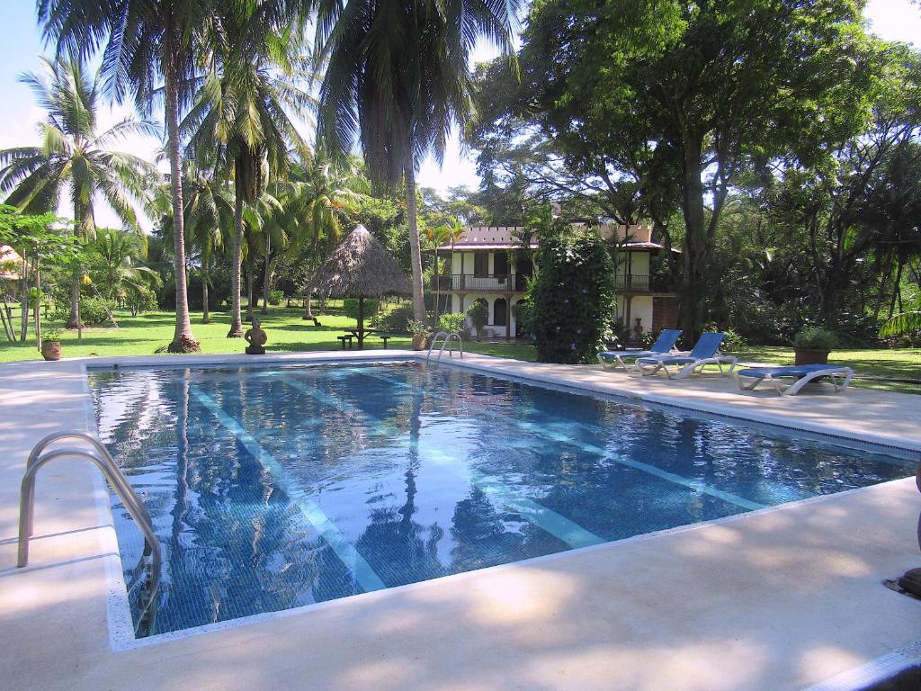 a swimming pool in front of a house at Paraiso Cocodrilo lodge - spirit of nature in Sámara