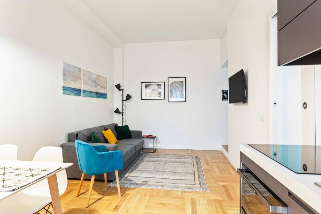 a living room with a couch and a table at Easylife - Milano - D'Annunzio - Navigli in Milan