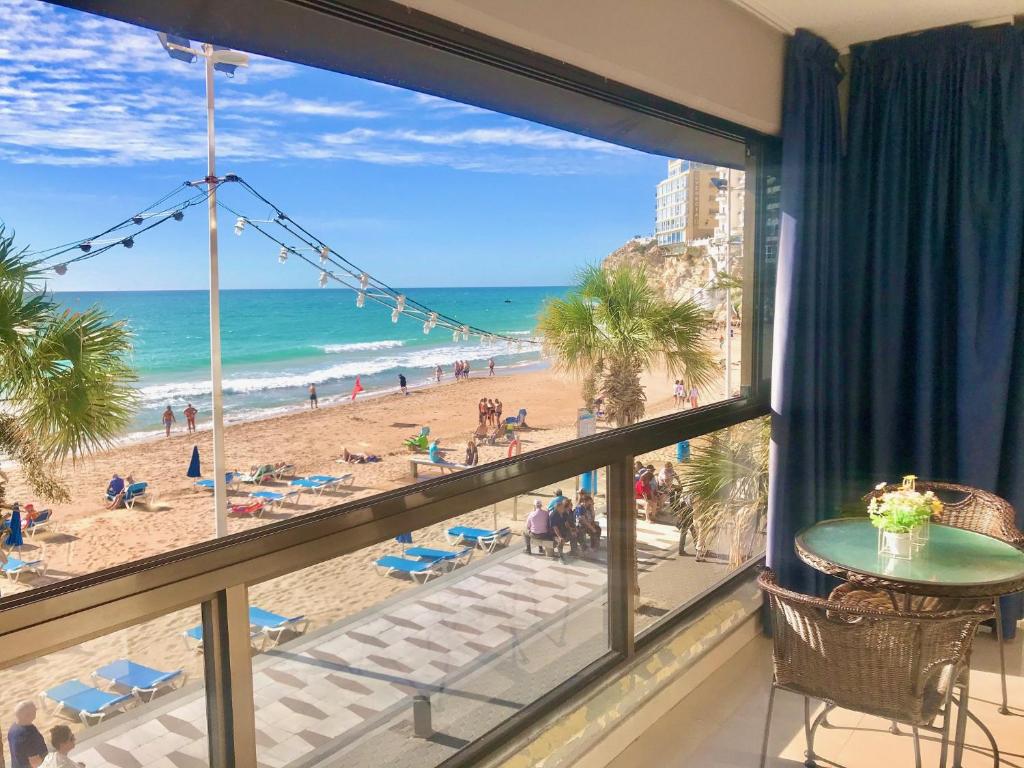 a room with a view of the beach and the ocean at Seafront Levante Beach Blueline in Benidorm