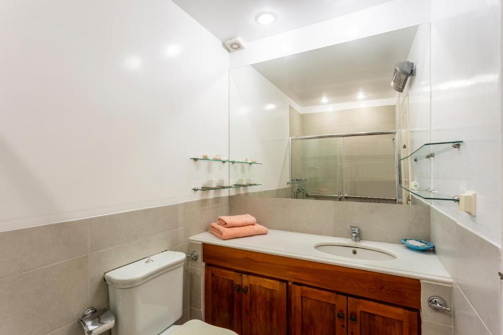 a bathroom with a sink and a toilet and a mirror at Villa Ponente in Spetses