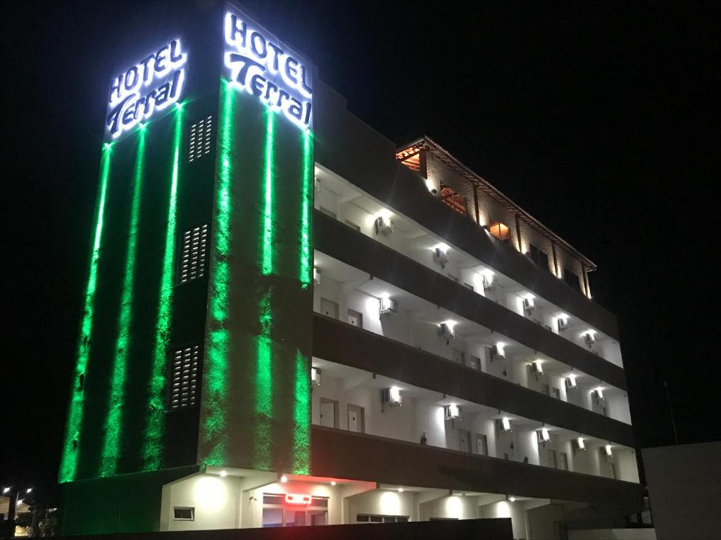 a building is lit up in green and white at Hotel Terral in Pindoretama