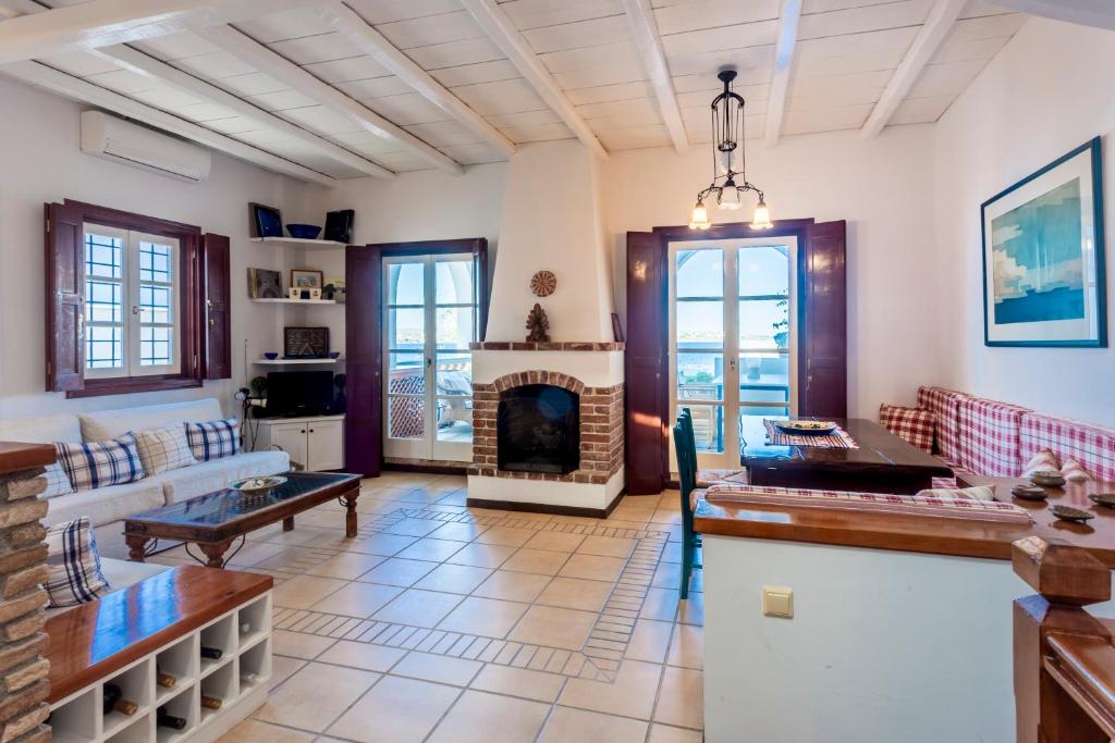 a living room with a couch and a fireplace at Villa Ponente in Spetses