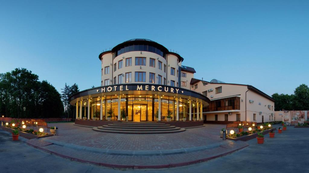 a hotel meyereville building with lights in front of it at Mercury Hotel in Kharkiv