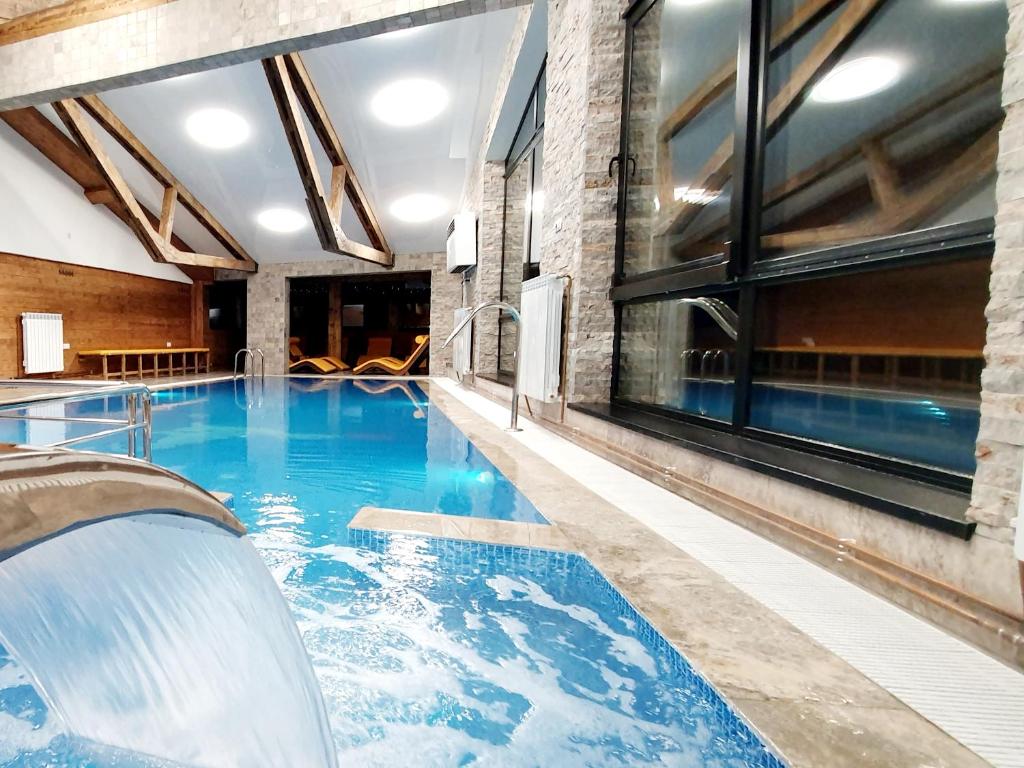 a pool in a building with a swimming pool at Hotel Superski in Cavnic