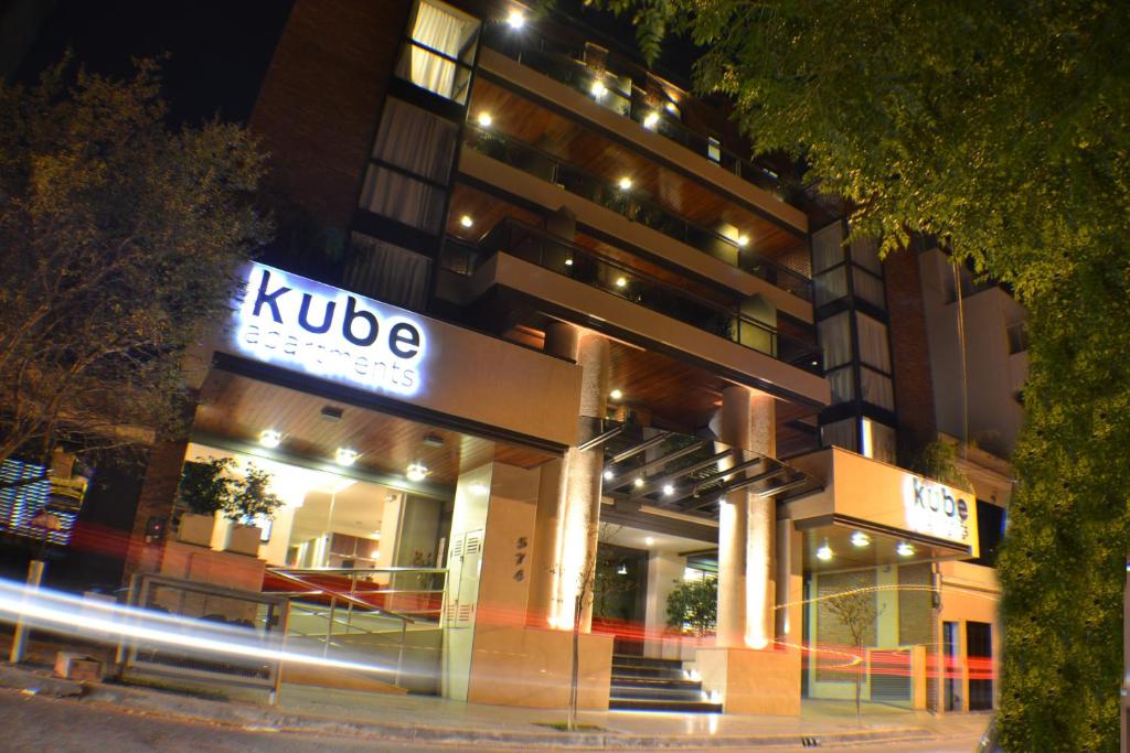 a building with a kupe sign at night at Kube Apartments Express in Cordoba