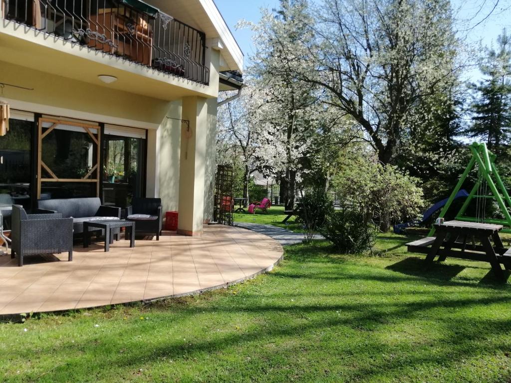 a patio with a picnic table and a playground at DOMEK Zielona Oaza in Polanica-Zdrój