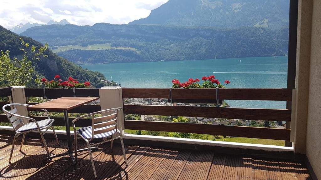 a balcony with a table and chairs and a view of a lake at Hotel Platten Apartment in Gersau