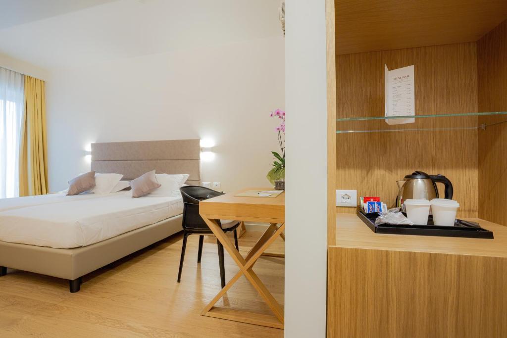 Postel nebo postele na pokoji v ubytování Hotel Politeama