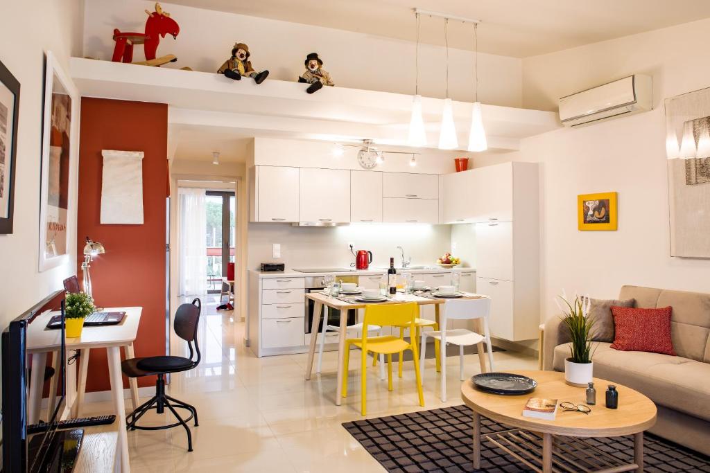 a kitchen and living room with a table and chairs at Anemi Apartments in Nafplio