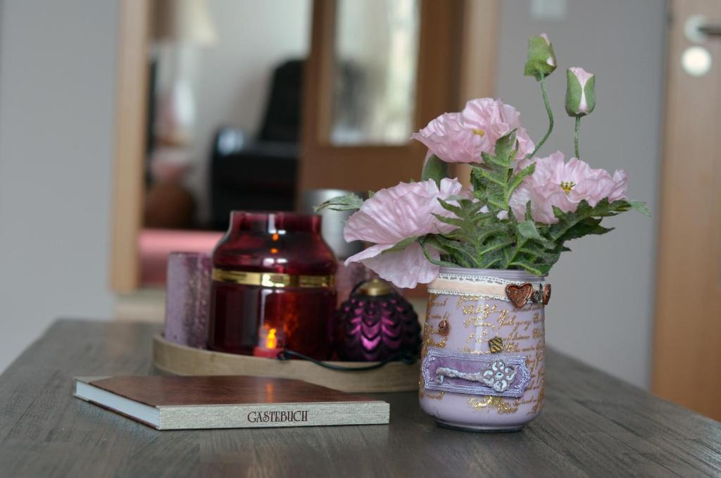 eine Vase voller rosa Blumen auf einem Tisch in der Unterkunft Ferienwohnung Marosa in Willingen