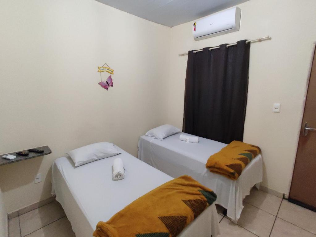 Uma cama ou camas num quarto em Pousada do Professor