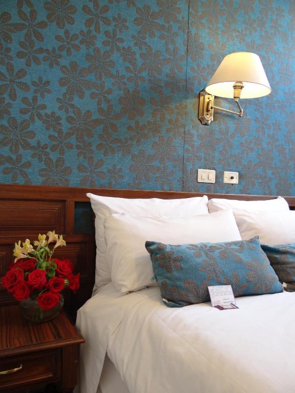 Postel nebo postele na pokoji v ubytování Hotel Real Audiencia