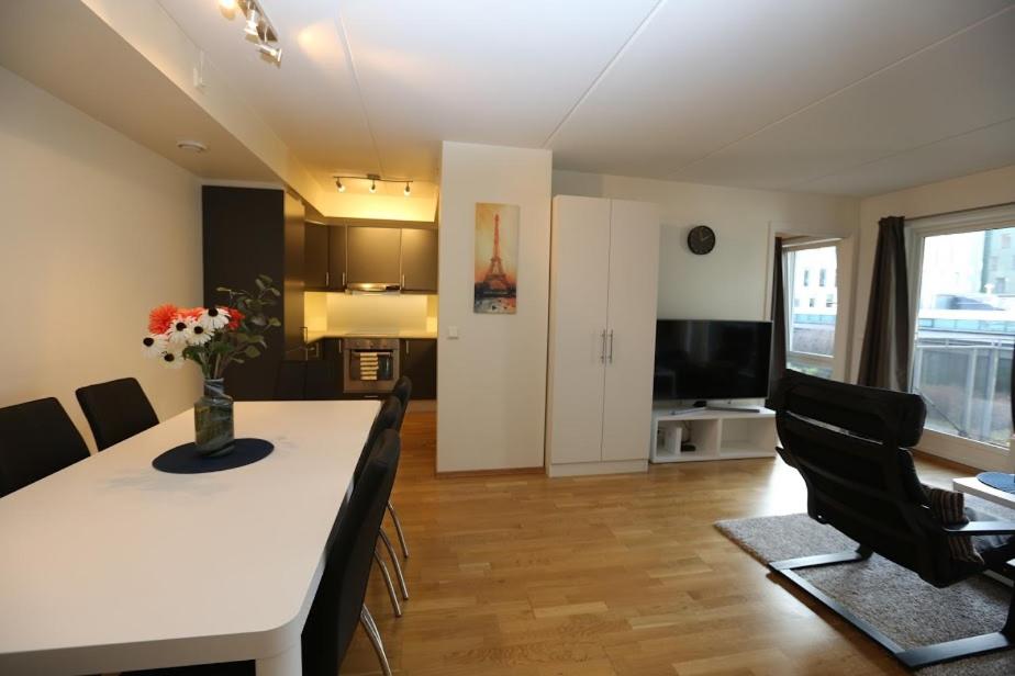 a dining room and living room with a table and chairs at OSLO CITY CENTER 3 BEDROOMS APARTMENT, MANDALLS GATE 12 in Oslo