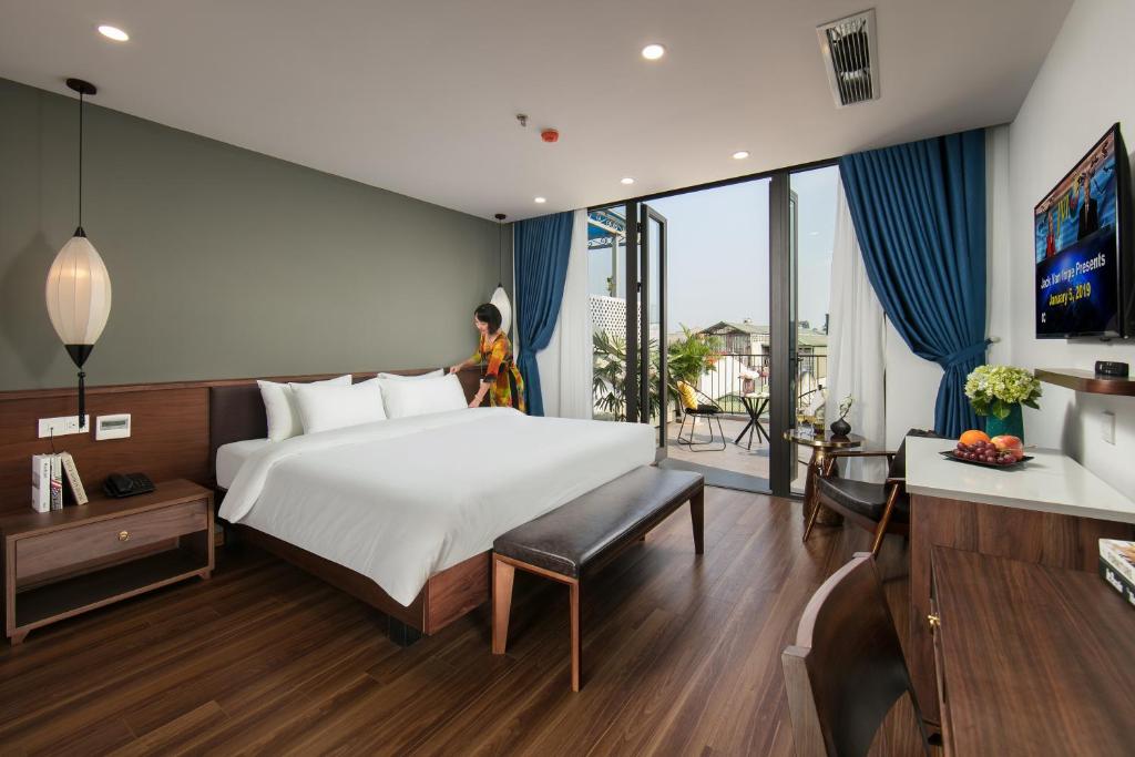 Giường trong phòng chung tại Hanoi Exclusive Hotel
