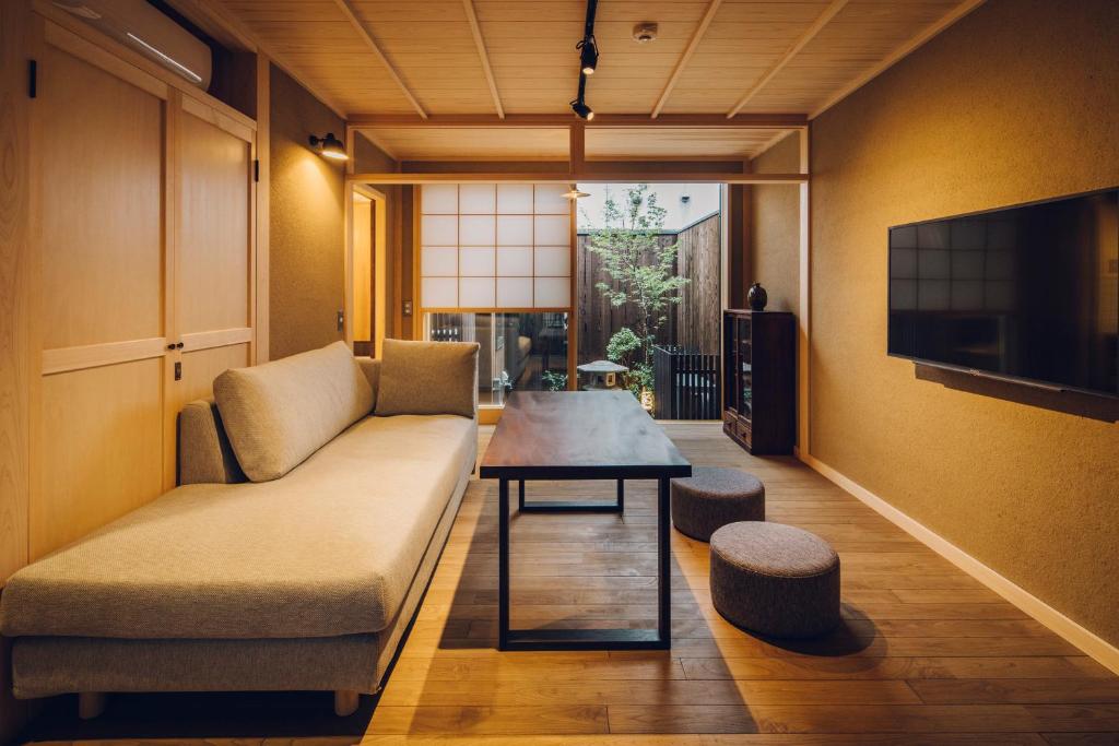 a living room with a couch and a table at Someno House Kyoto Dog Friendly in Kyoto