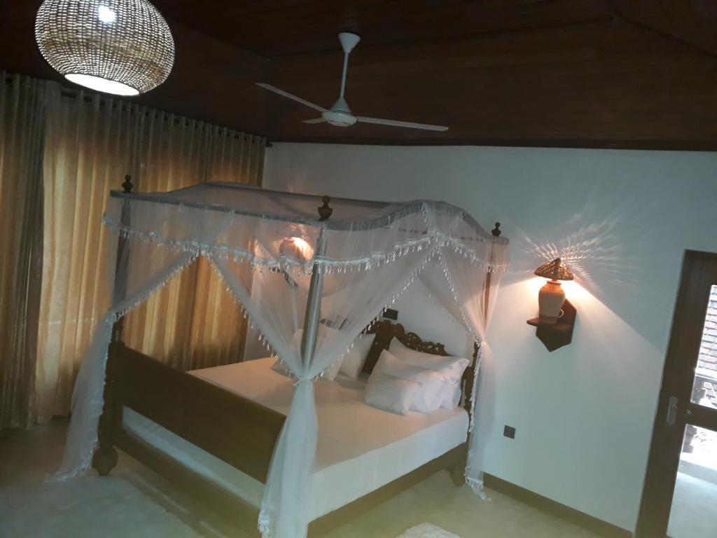 a bedroom with a bed with a canopy at Selnara Private Luxury Villa and Ayurveda Spa in Bentota