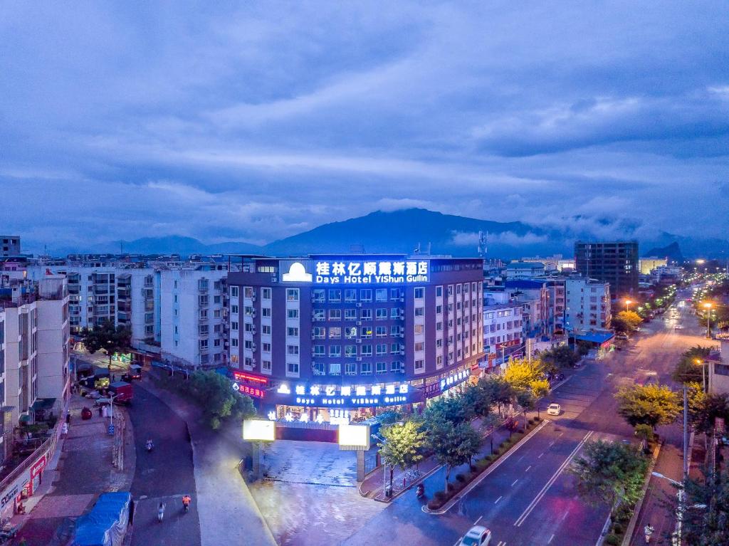 a view of a city at night with buildings at Days Hotel Yishun Guilin in Guilin