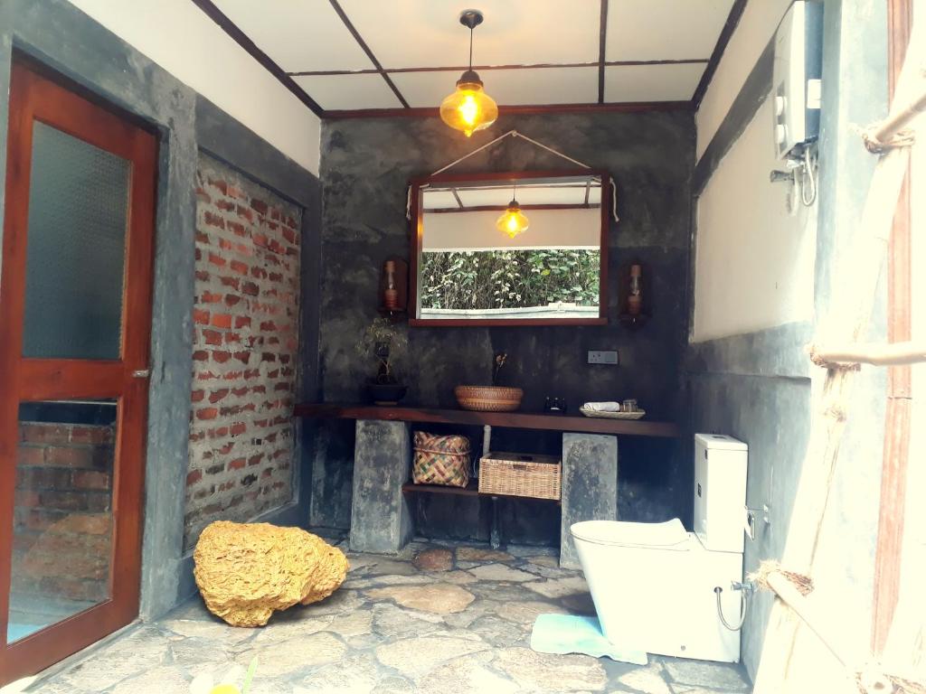 a bathroom with a toilet and a window at Selnara Private Luxury Villa and Ayurveda Spa in Bentota