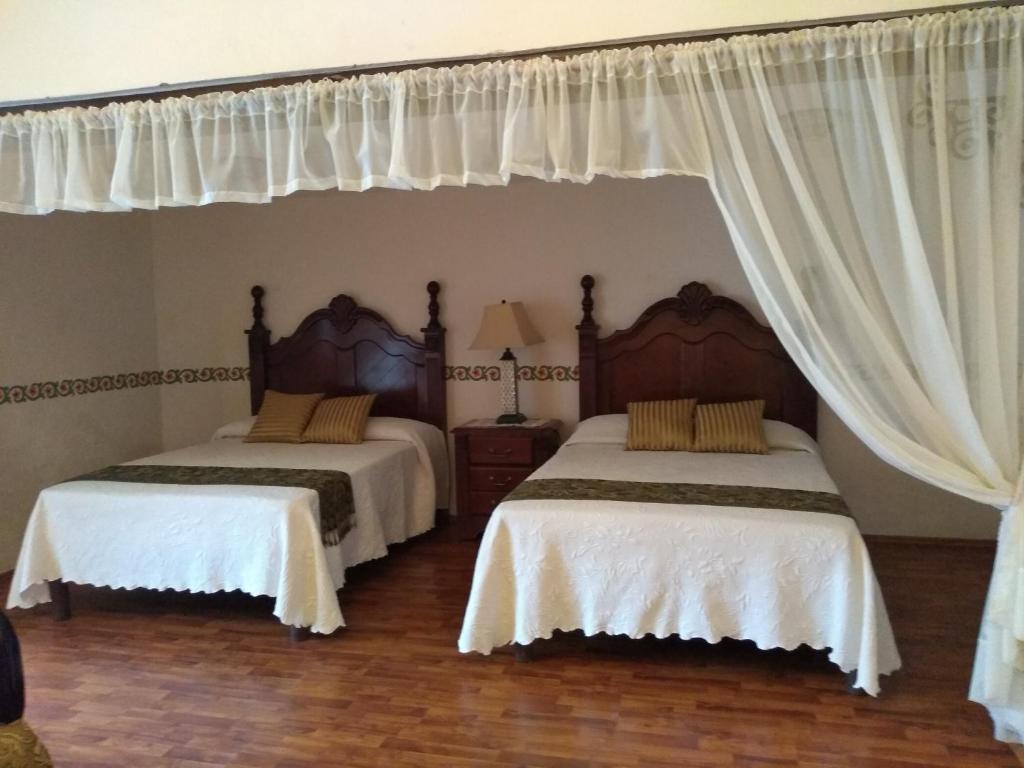 Postel nebo postele na pokoji v ubytování Hotel Spa Hacienda Real la Nogalera
