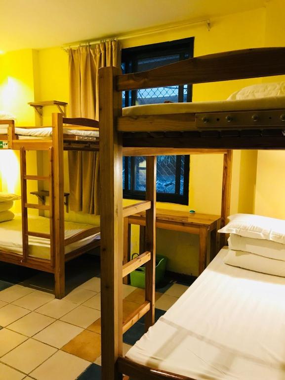 Postel nebo postele na pokoji v ubytování Hofang Guest House