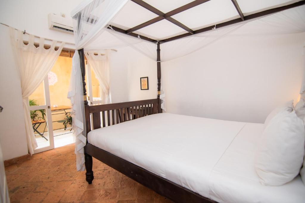 Postel nebo postele na pokoji v ubytování Mango House - Galle Fort