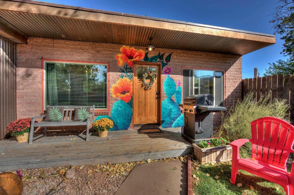 a house with a deck with a grill at Desert Gardens #3 in Moab