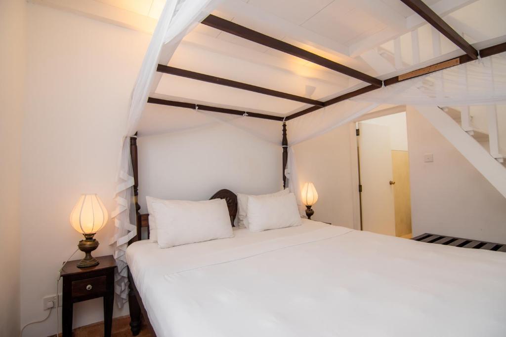 Postel nebo postele na pokoji v ubytování Mango House - Galle Fort