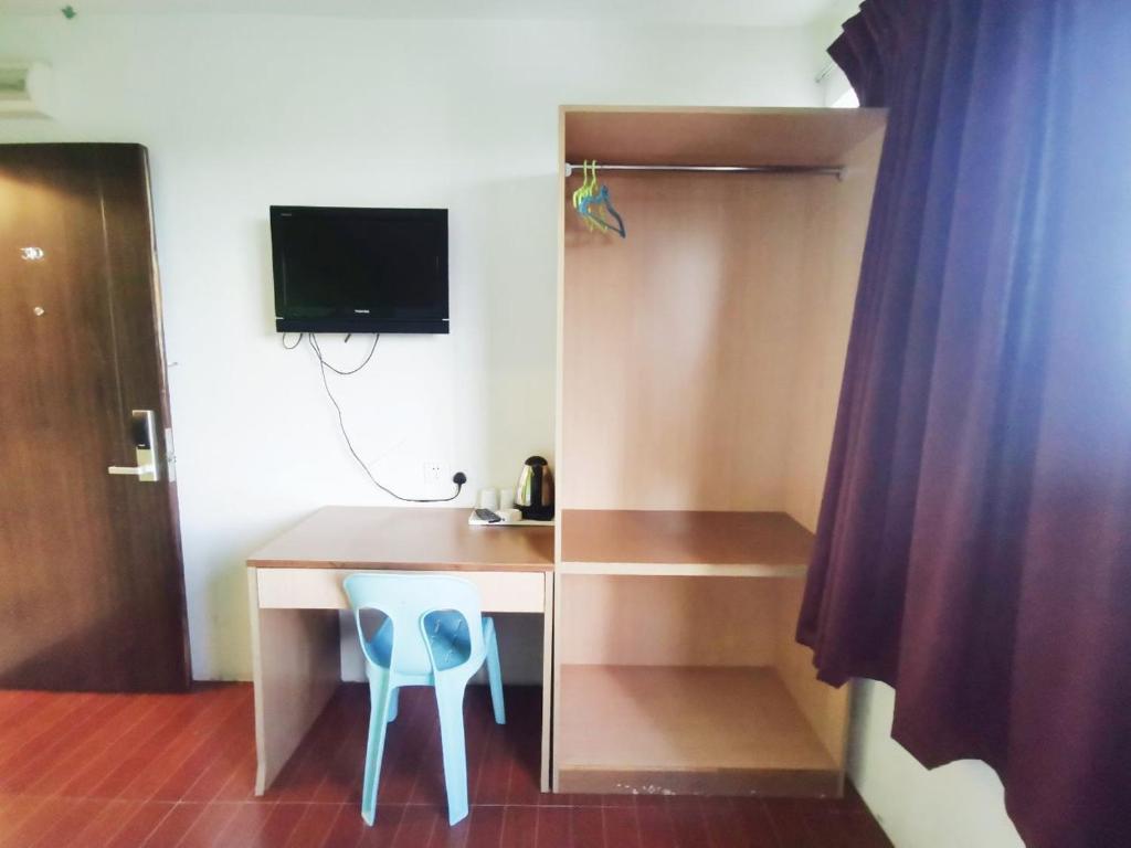 TV a/nebo společenská místnost v ubytování Homestay Kuching Hotel
